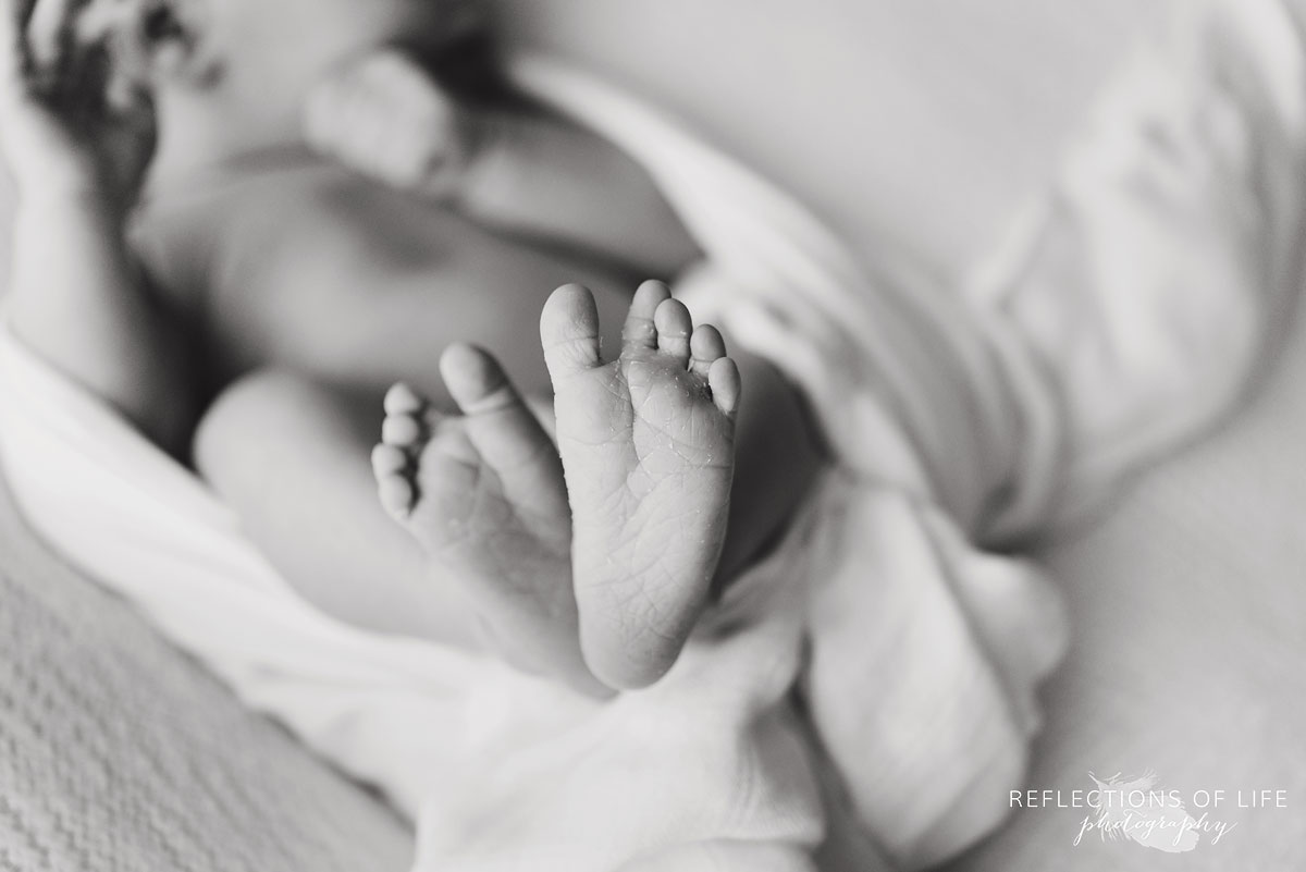 newborn baby girl feet candid