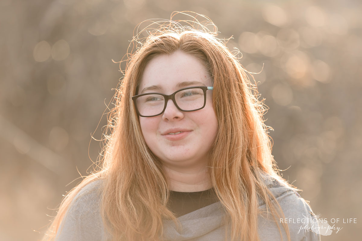 Beautiful redheaded girl in the light of sunset