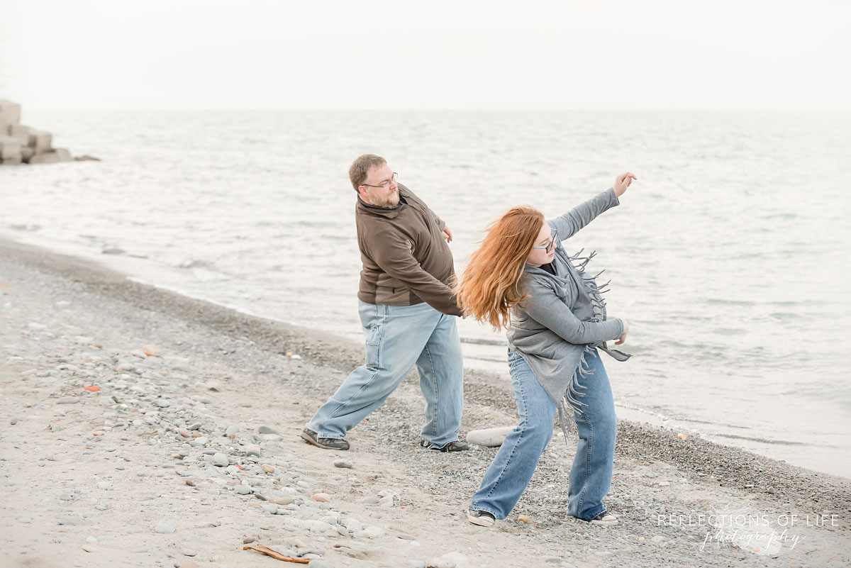 Father and daughter throwing stones into the water Grimsby Ontario