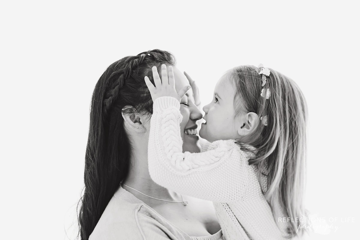Black and white of mother and daughter smiling