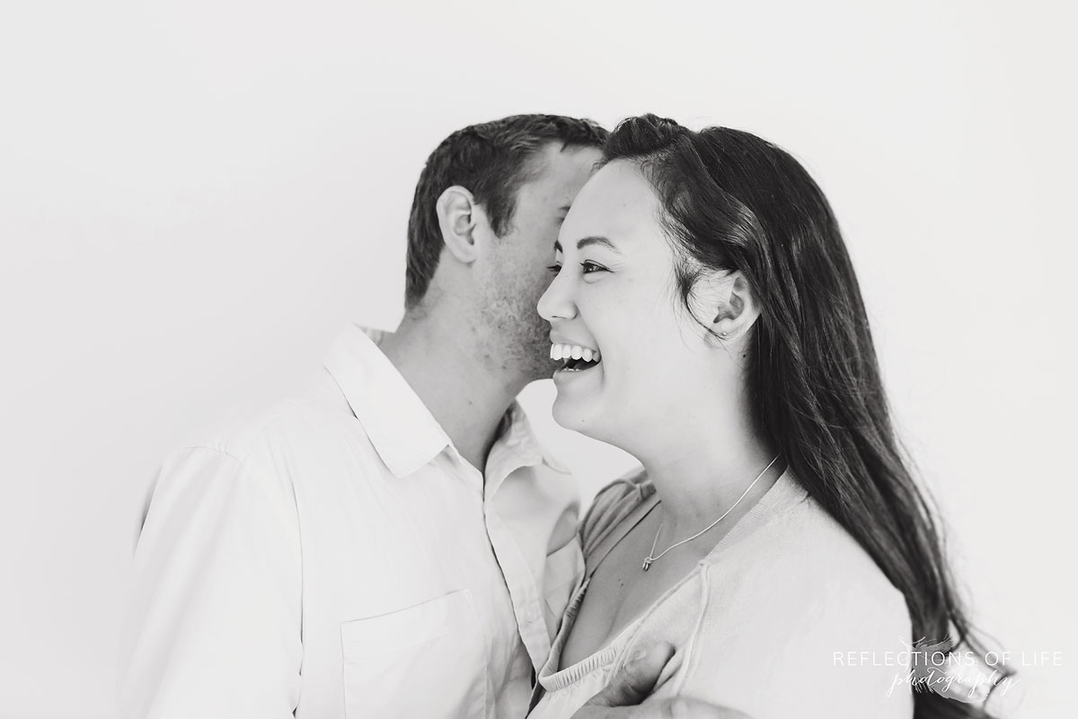 Candid of husband telling wife something to make her laugh