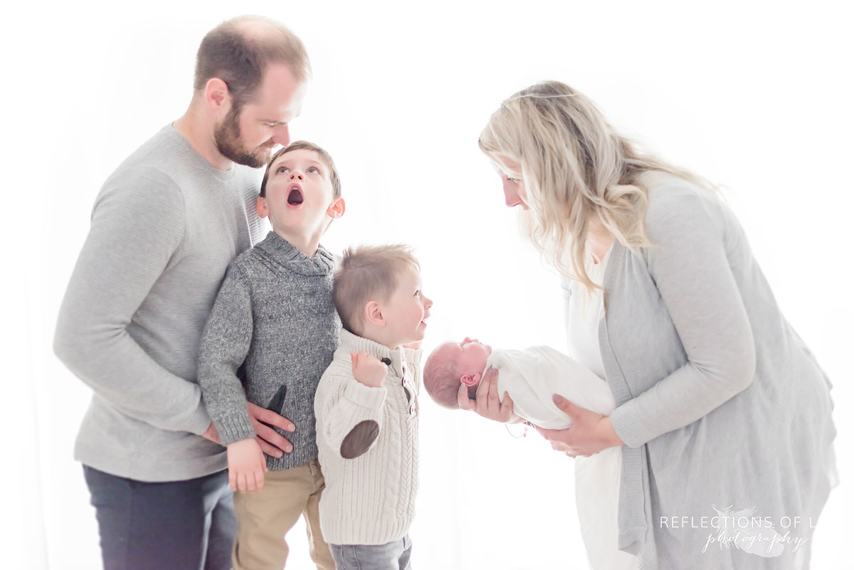 family photo of newborn in natural window light