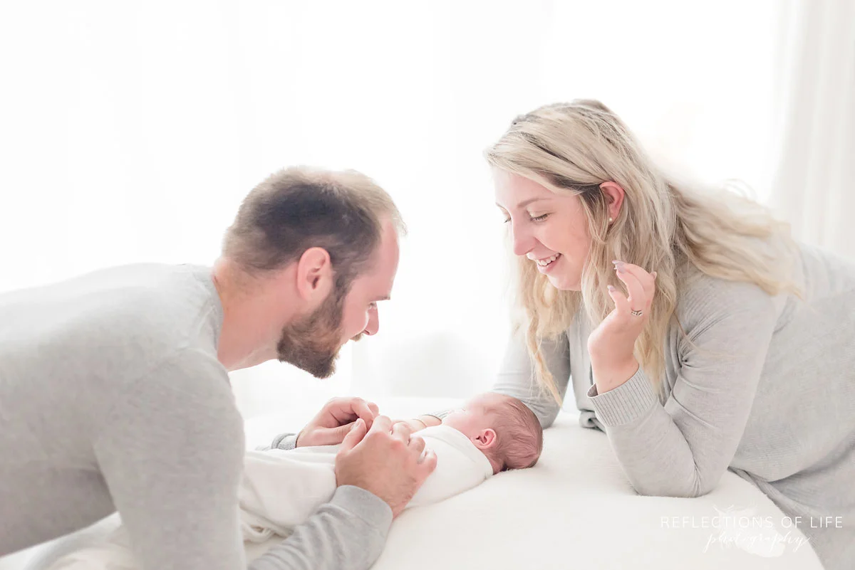 Adorable photo of mom dad and baby boy in natural light
