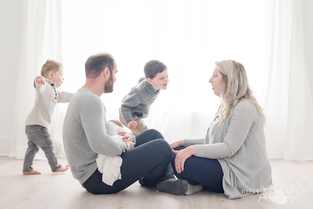 Family playing slow motion superheros in Natural light photo studio Niagara Ontario