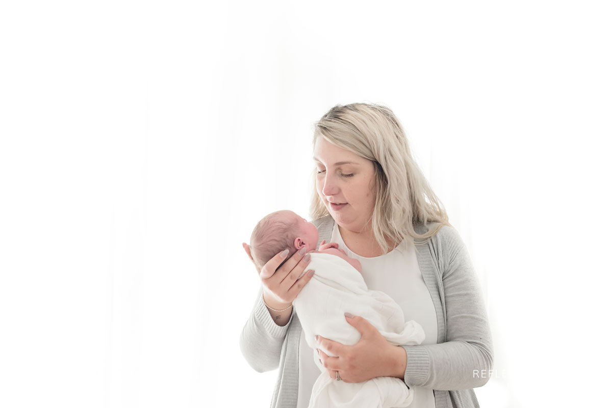 Mom looking down at her newborn baby boy