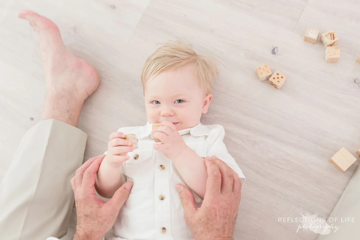 Photography grandpa and grandson playing on floor together