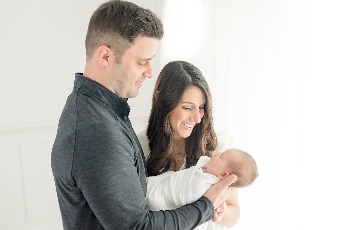 Mother and father looking at baby in niagara