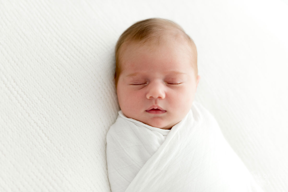 Baby girl sleeping in white studio grimsby ontario