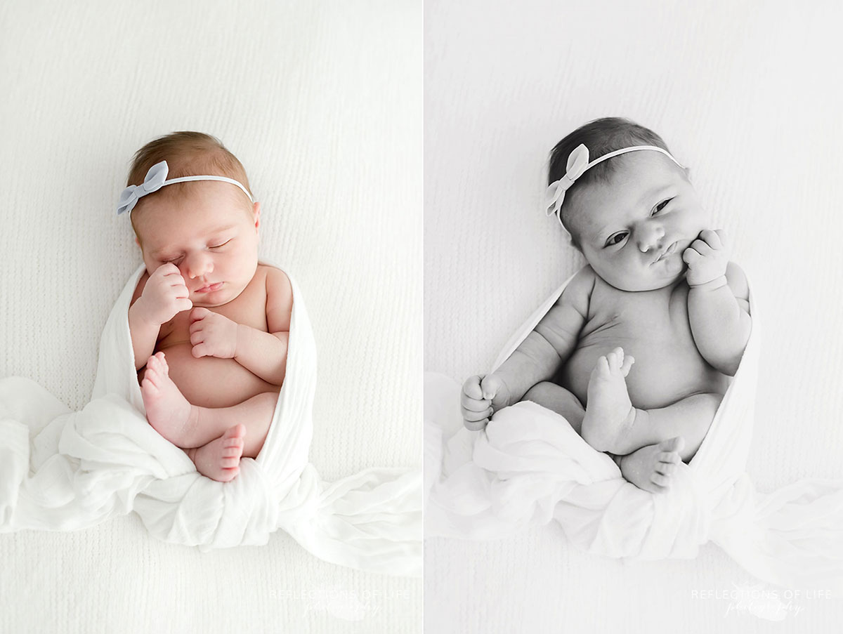 Baby girl with bow in hair wrapped in white