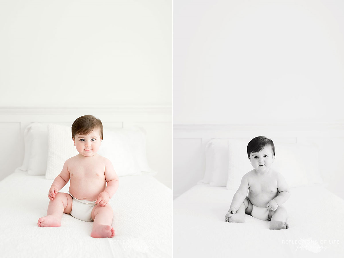 Baby sitting on white couch in white studio