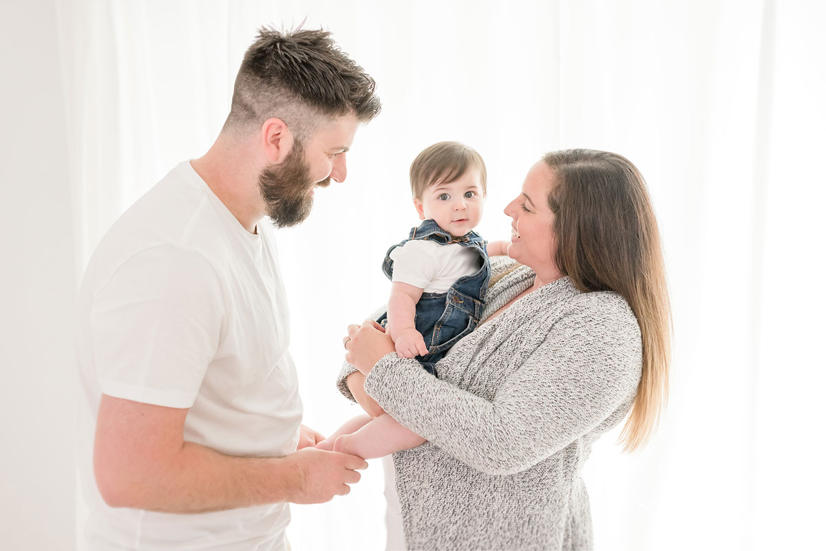 Mother holding baby and father holding baby toes