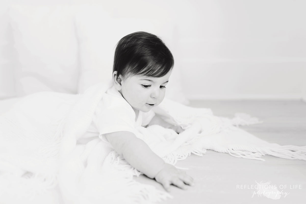 Baby looking down black and white