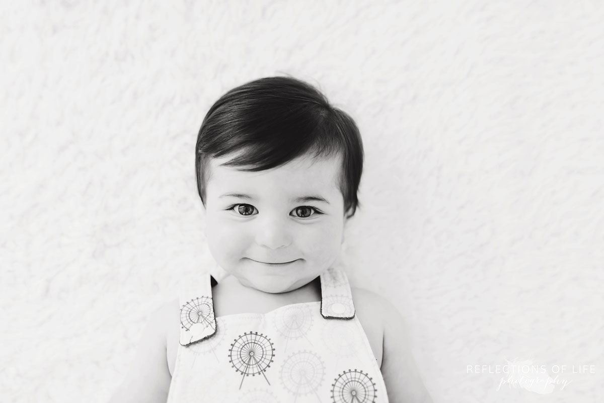 Black and white of baby smiling at camera