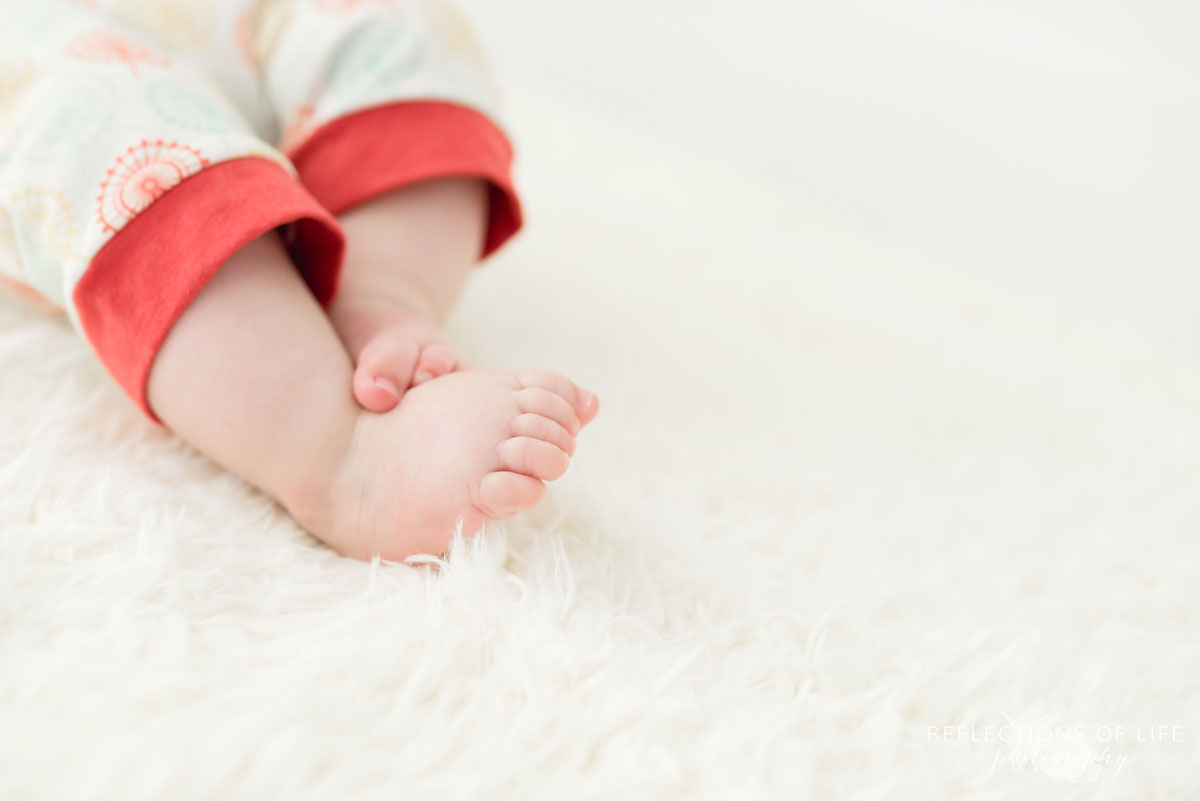 Baby toes on white blanket