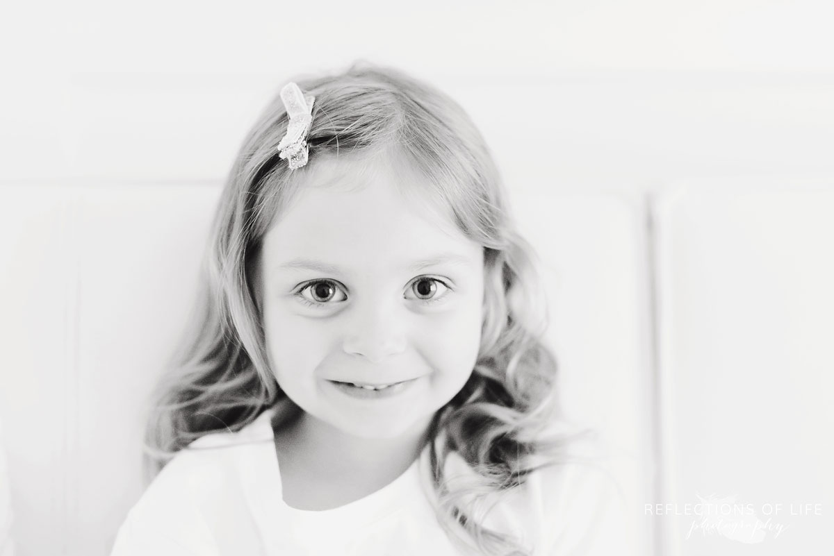young girl looking at camera and smiling