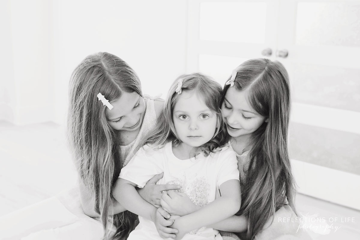 portrait of three sisters sitting together