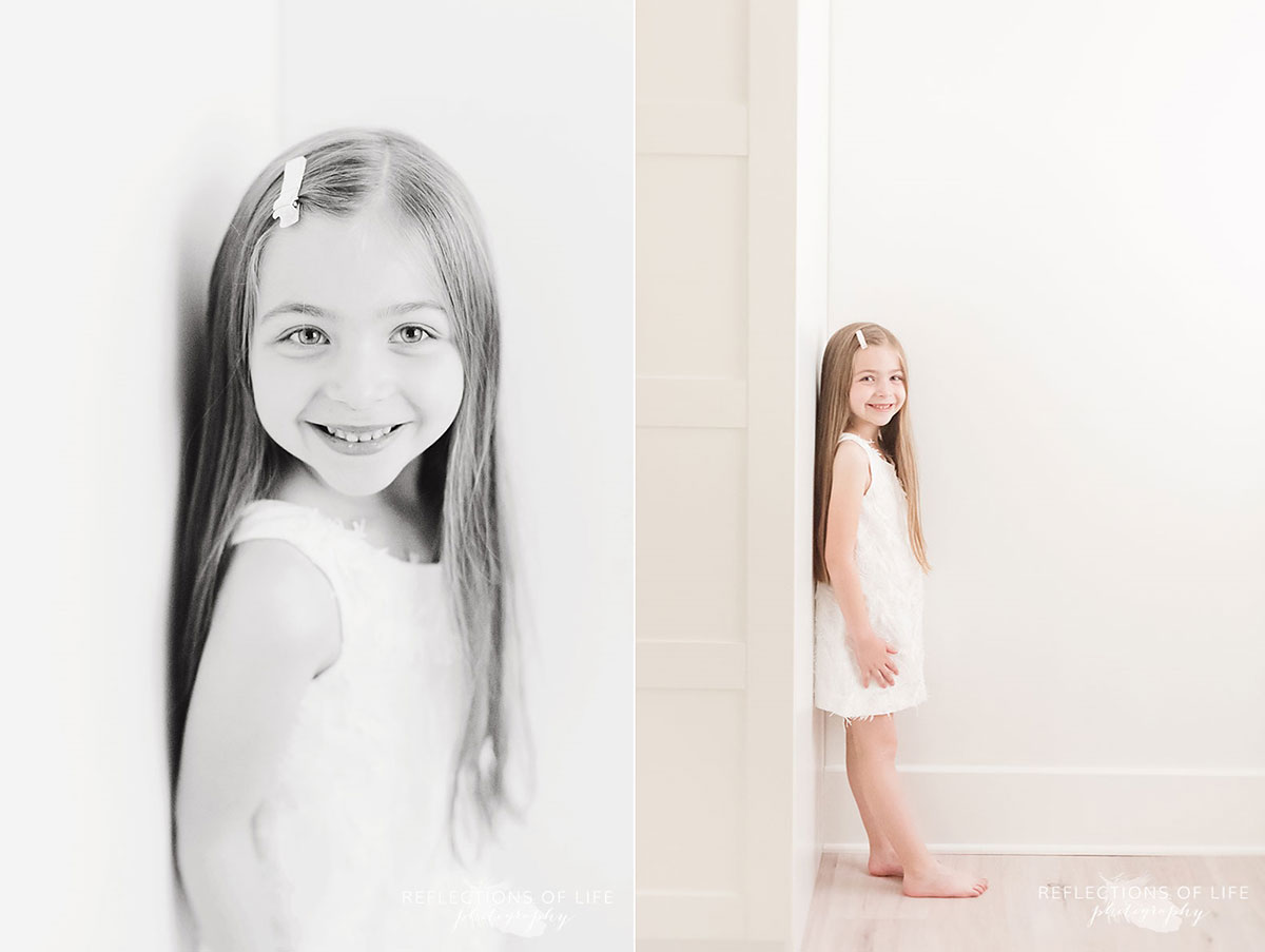 young girl leaning up against wall in studio