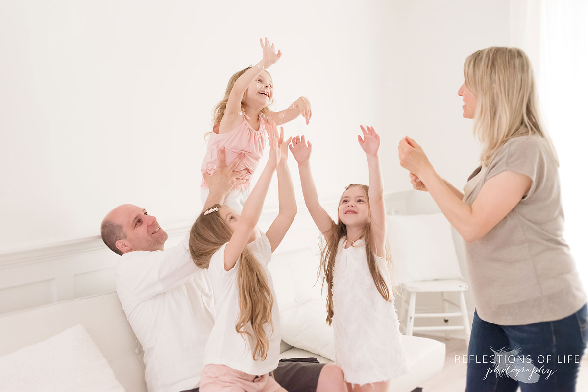 three sisters and parents playing