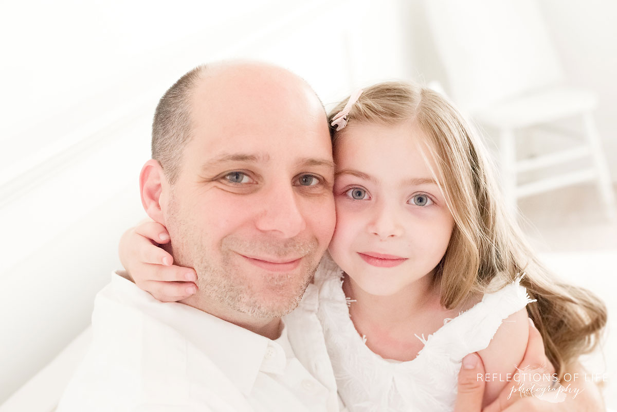 dad and daugther looking into camera smiling