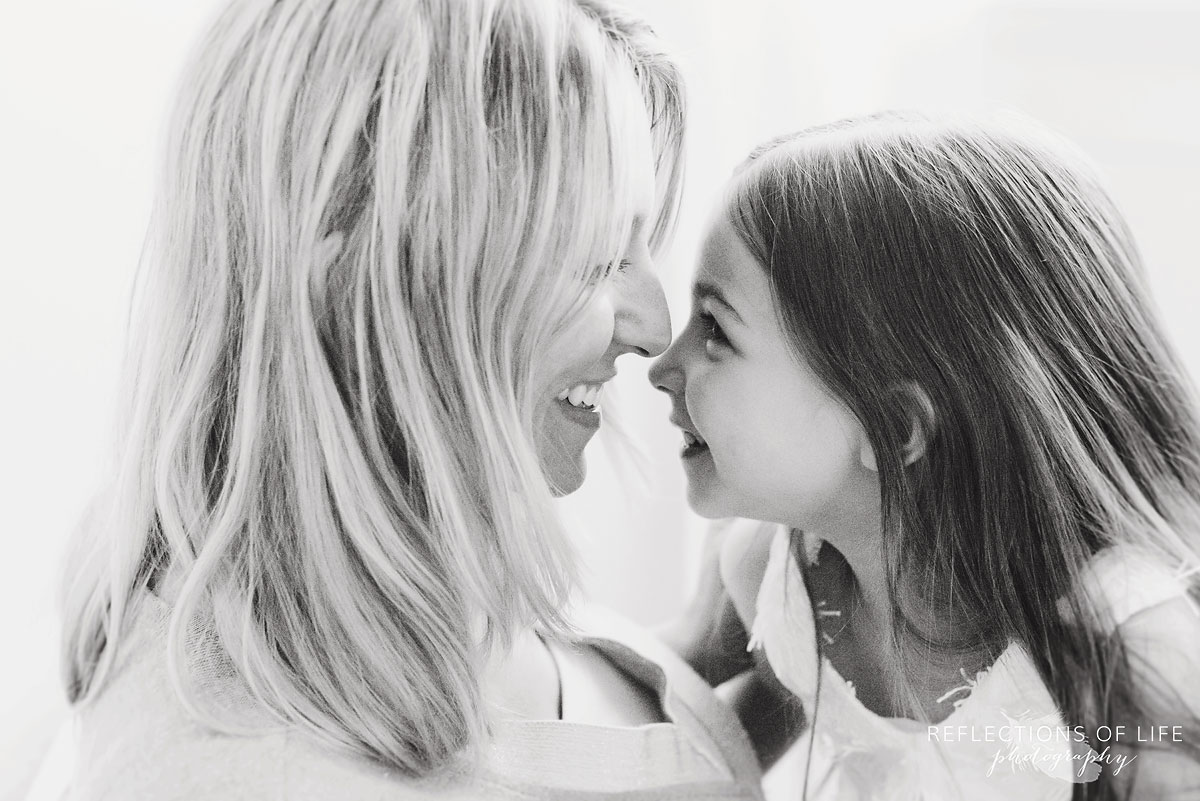 mother and daughter looking at each other smiling