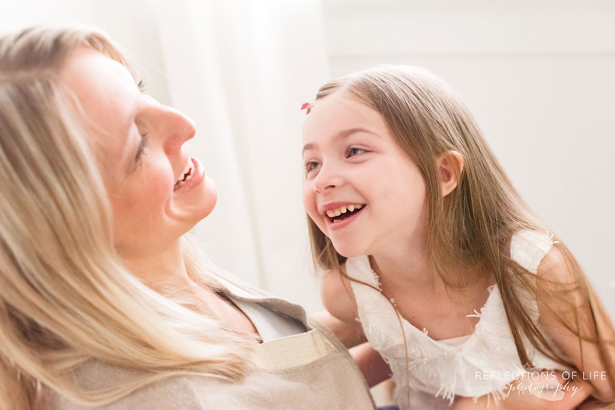 mom and daughter laughing together