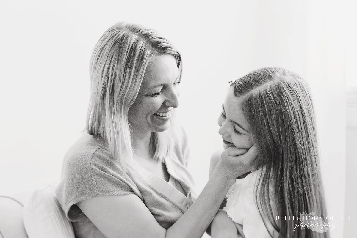 mom and daughter in studio with white background