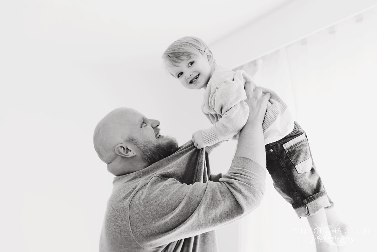 black and white dad and son playing in studio
