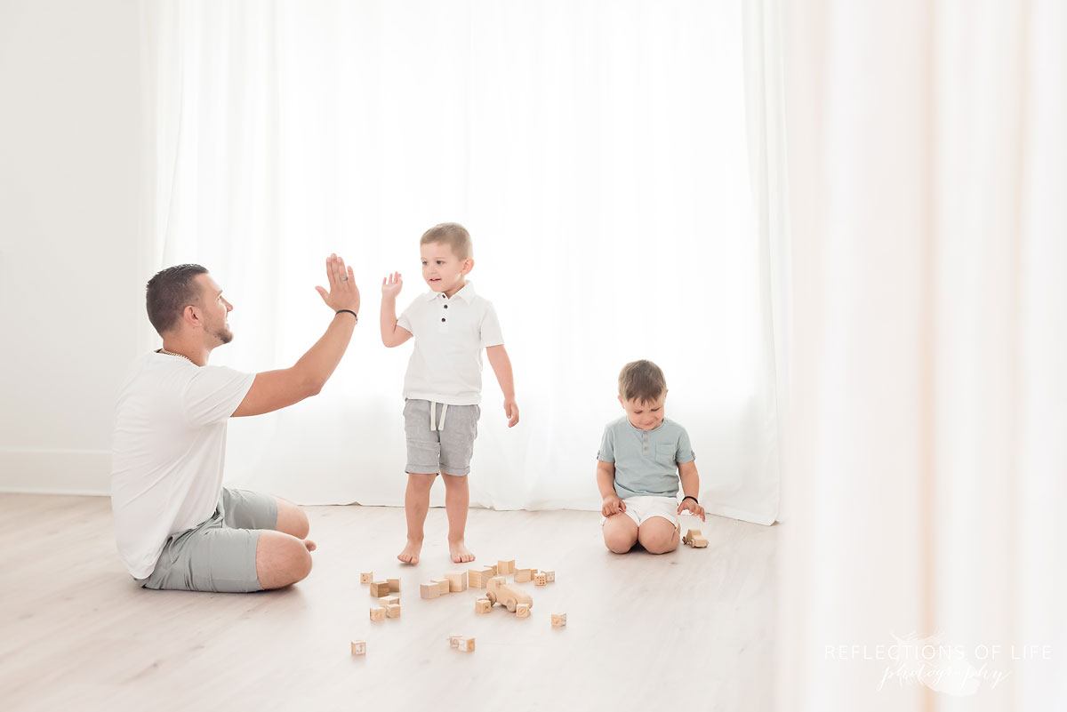father and son high five in studio