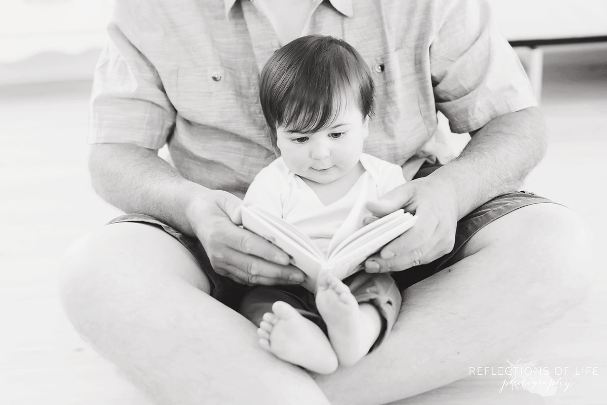 grandpa and grandson reading together black and white