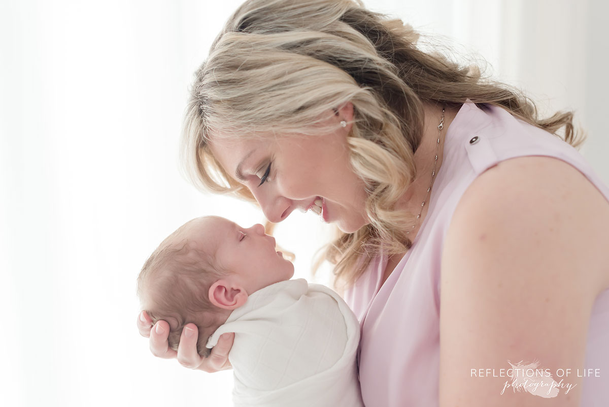 portrait of mom holding son white background.jpg