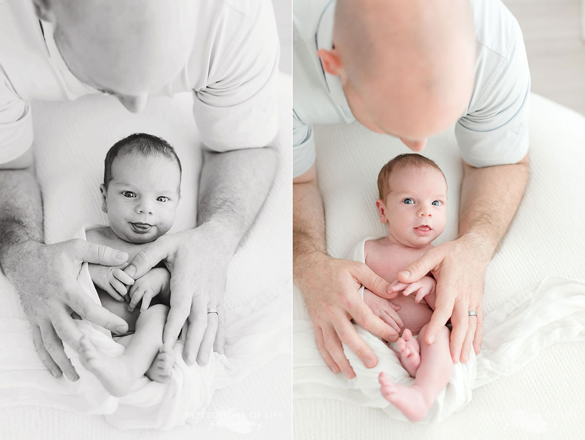 baby laying on white pillow while dad is holding him