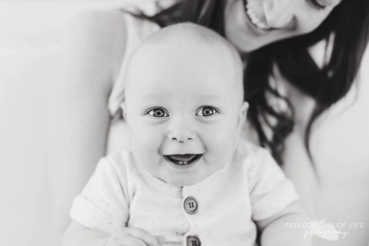 baby smiling at camera black and white.jpg