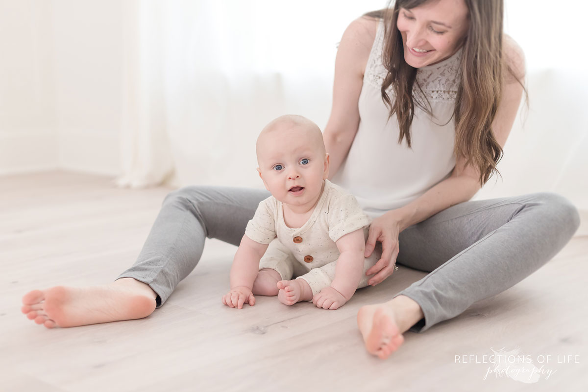 mom and baby sitting on the floor together in studio.jpg
