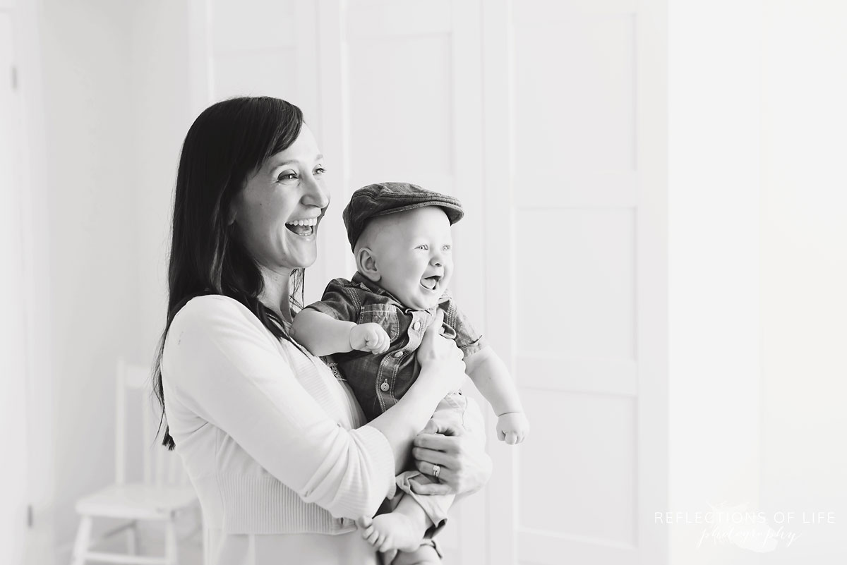 mom holding baby boy in studio black and white.jpg