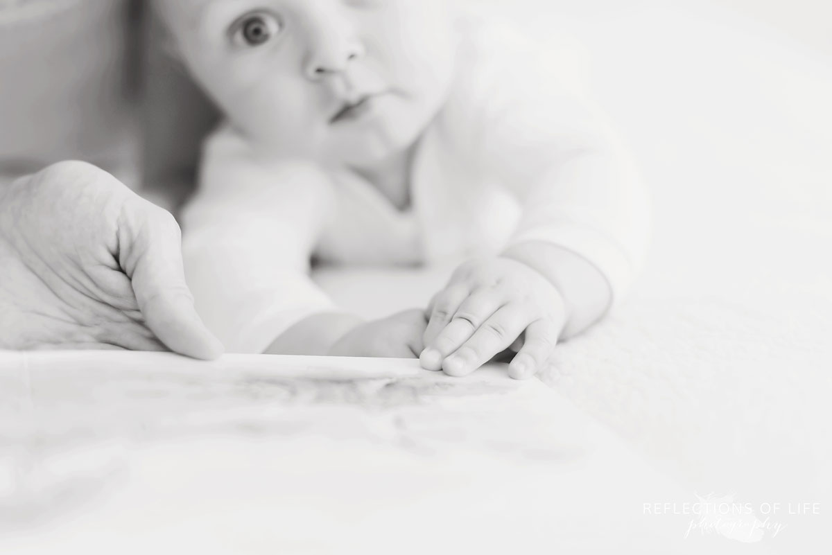 baby boy reading book black and white.jpg