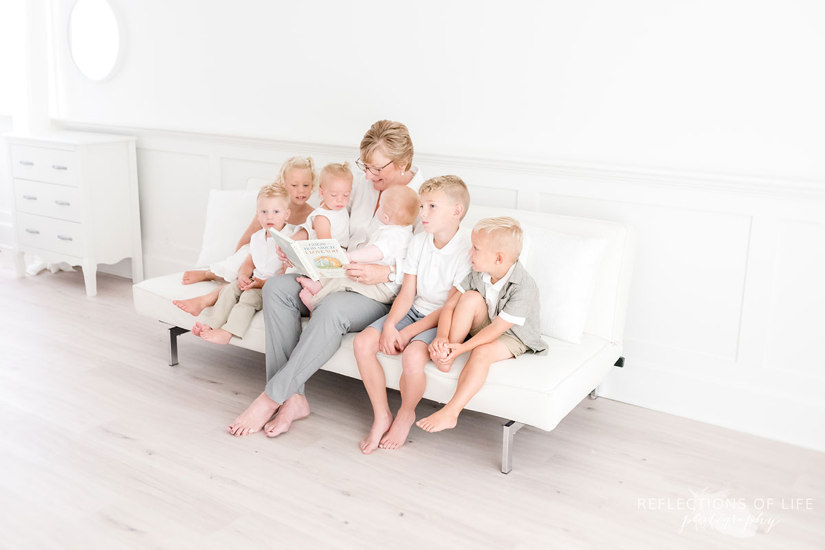 Grandma reading to her grandkids in natural light studio in Grimsby Ontario