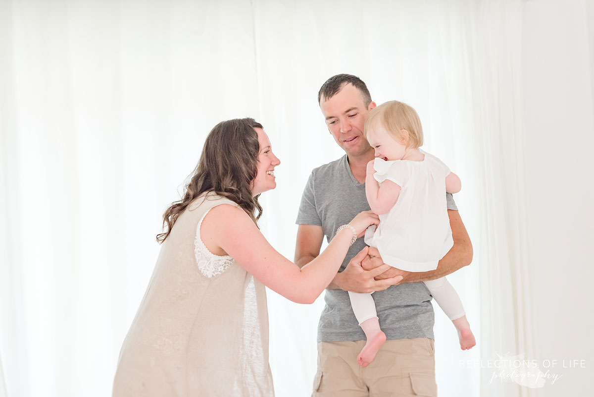 daddy mommy and daughter have a dance in the photo studio