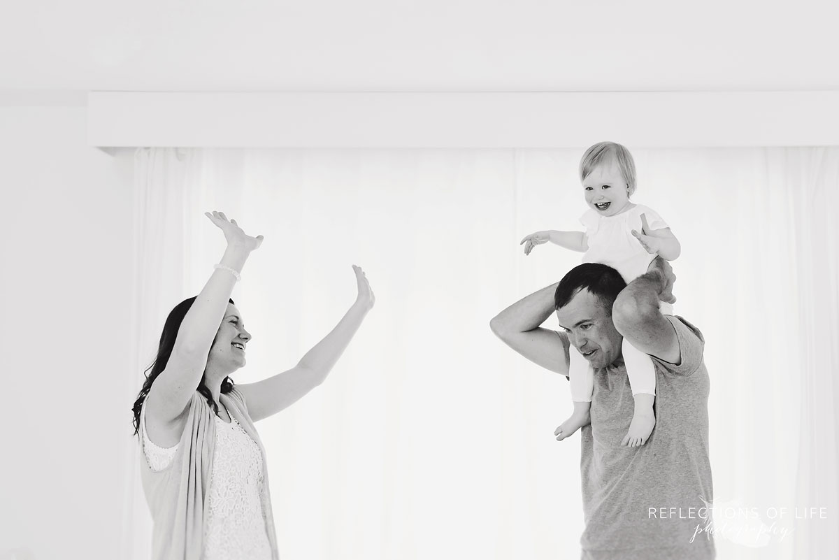 mom and dad dance with daughter at niagara ontario photo studio