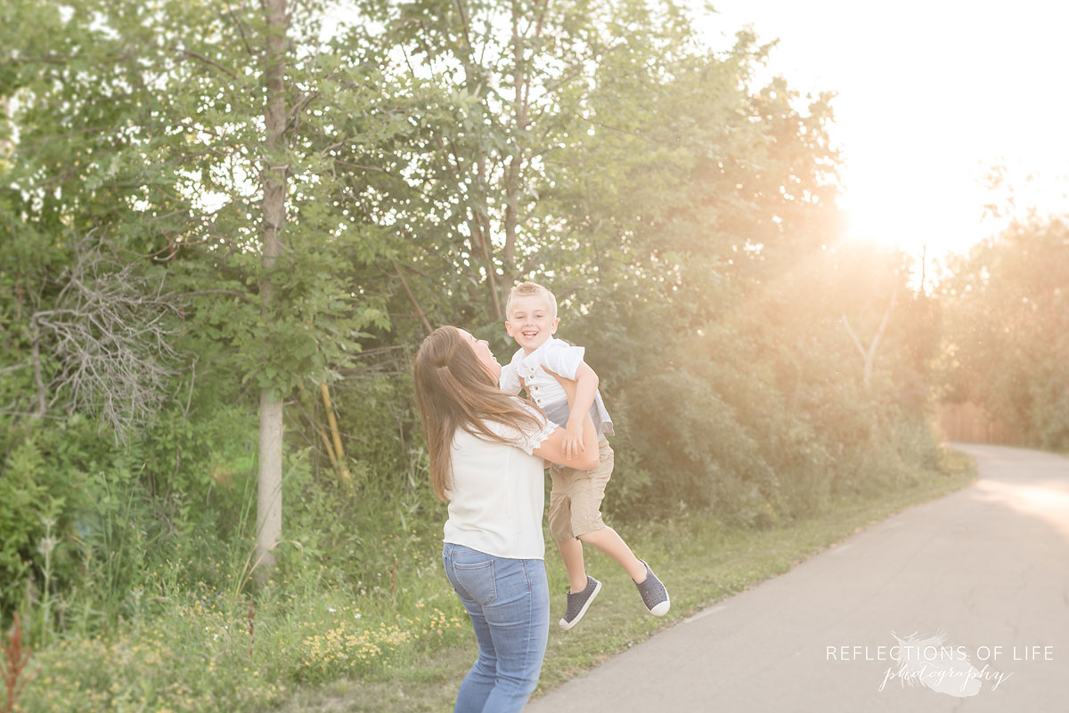 mother holding her son up in the air