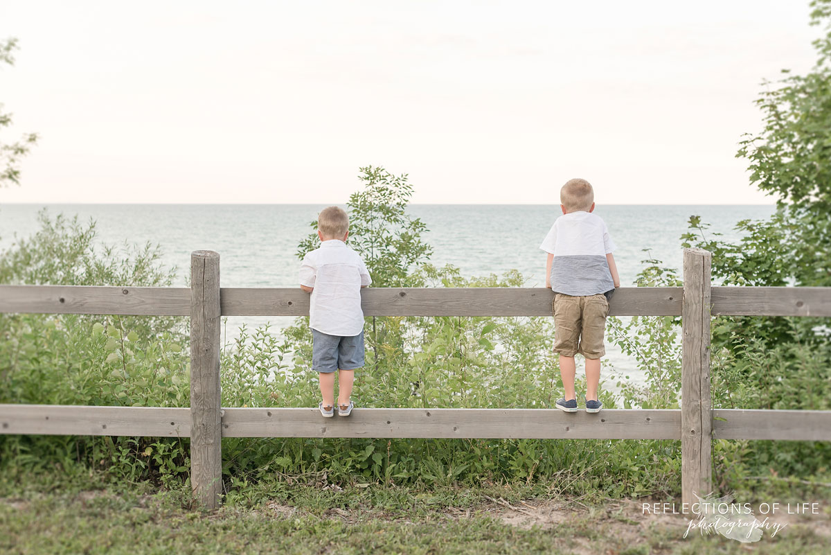 Little boys looking over the fence at Casablanca Beach in Grimsby