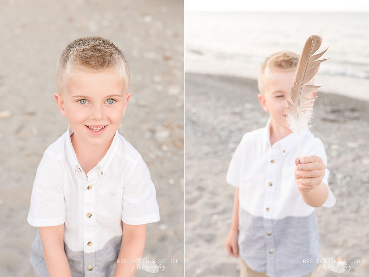 Boy playing with feather at Grimsby beach in Ontario