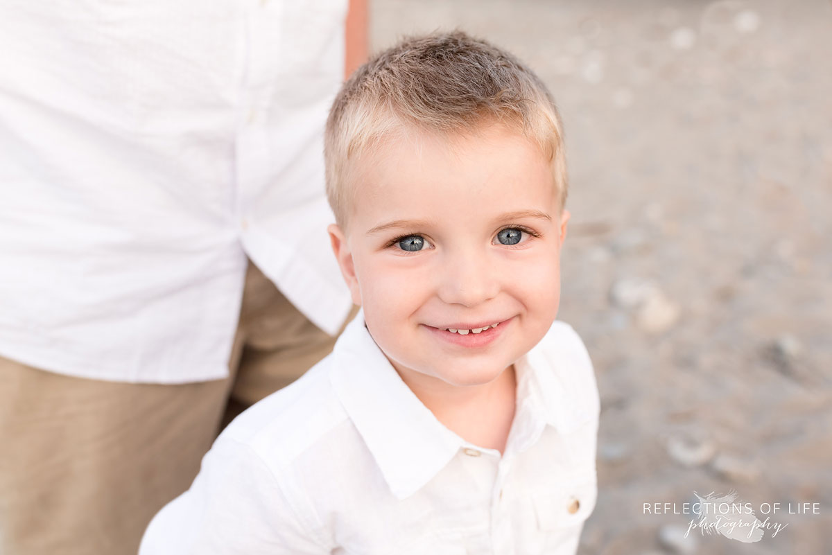 Little boy smiling into the camera