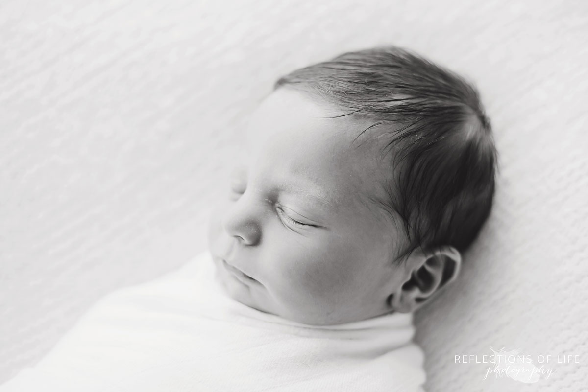 newborn baby boy side profile in black and white