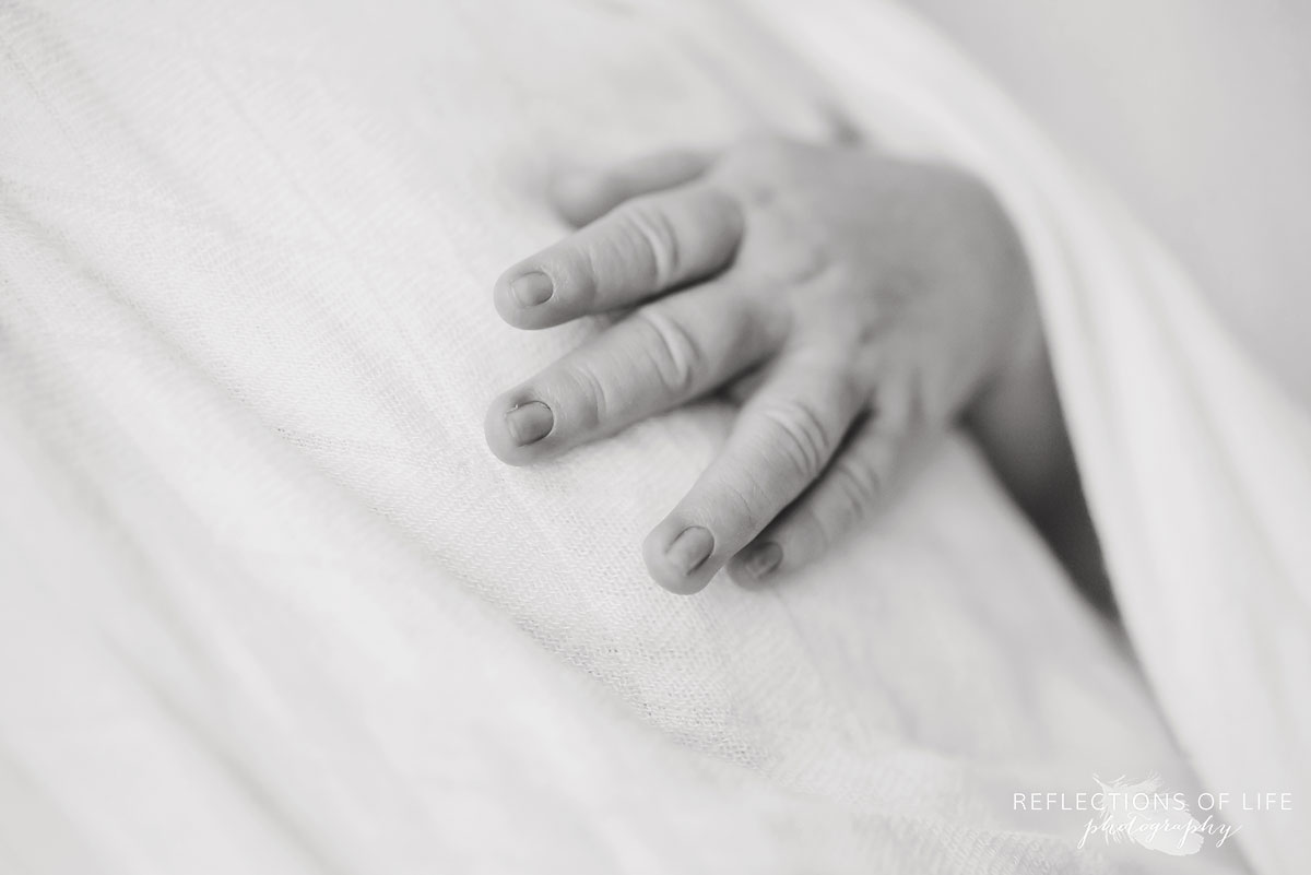 newborn baby boy finger and hands in black and white