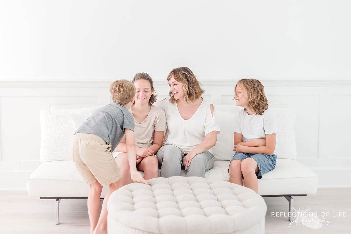 family laughing and playing games candidly in the studio.jpg