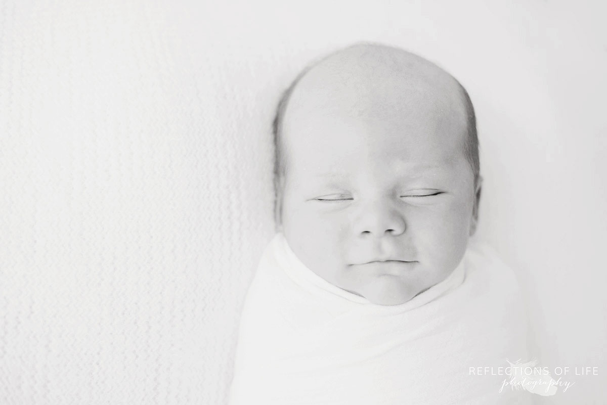 Black and white image of newborn baby boy