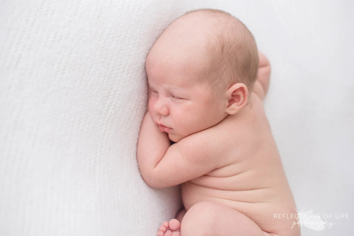 Cute photo of newborn baby boy with wrinkles on his back