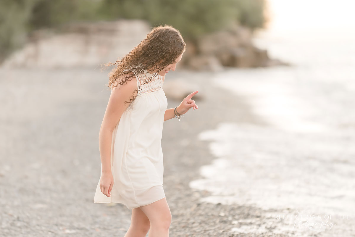 Girl walking along the beach with white dress