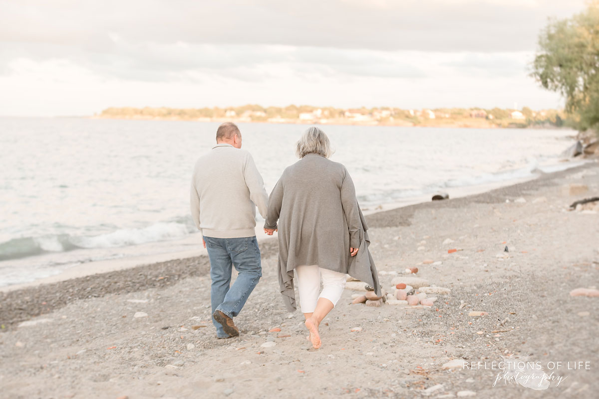 Husband and wife walking along Casablanca Beach in grimsby ontario