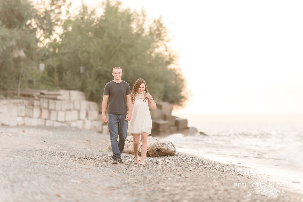 Girl and boy walking on the beach in Niagara Region